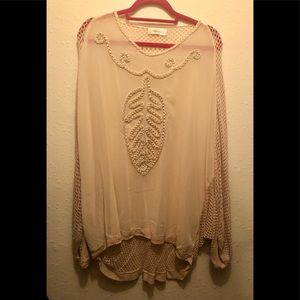 Very summer and breezy sheertop with crochet back.